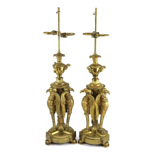 40 - A pair of Empire Revival ormolu table lamps, modelled as urns raised upon eagle monopodia, overall 9... 