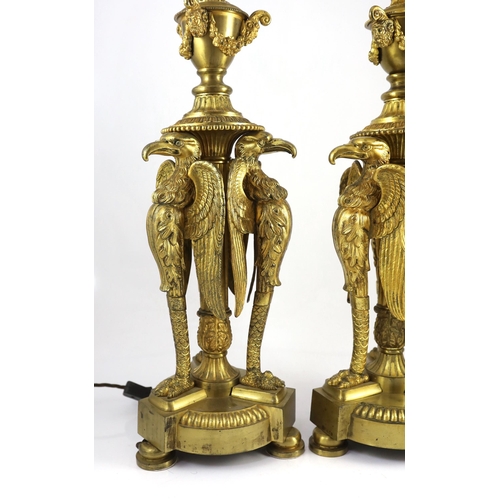 40 - A pair of Empire Revival ormolu table lamps, modelled as urns raised upon eagle monopodia, overall 9... 