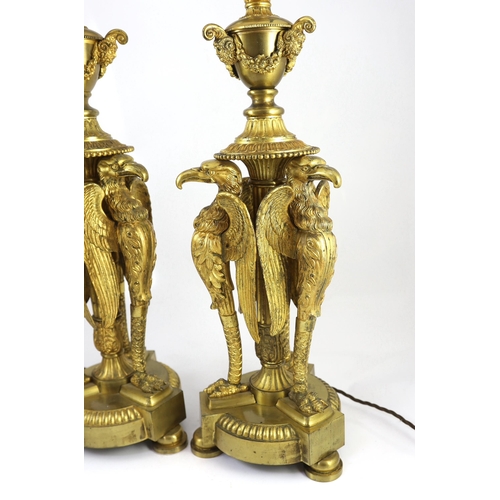 40 - A pair of Empire Revival ormolu table lamps, modelled as urns raised upon eagle monopodia, overall 9... 