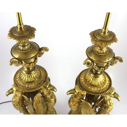 40 - A pair of Empire Revival ormolu table lamps, modelled as urns raised upon eagle monopodia, overall 9... 