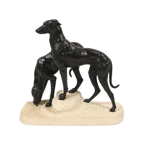 57 - Jules Edmund Masson (French, 1871-1932). A French Art Deco bronze group of two hounds, on naturalist... 