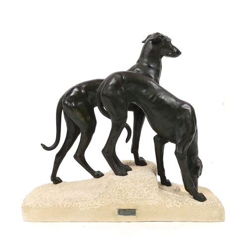 57 - Jules Edmund Masson (French, 1871-1932). A French Art Deco bronze group of two hounds, on naturalist... 