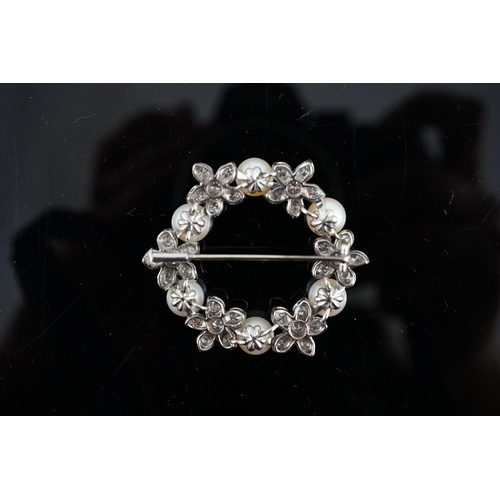 642 - A late 20th century white gold cultured pearl and diamond cluster set openwork circular brooch, with... 