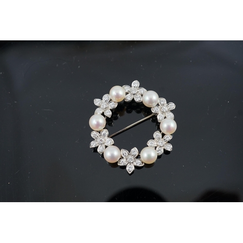 642 - A late 20th century white gold cultured pearl and diamond cluster set openwork circular brooch, with... 