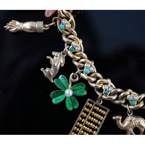 643 - An Edwardian 15ct gold, seed pearl and turquoise set curb link charm bracelet, the links with shamro... 