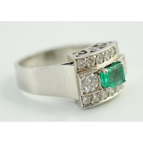 646 - A Swedish 18k gold, single stone emerald and fourteen stone diamond set three row cluster ring, the ... 