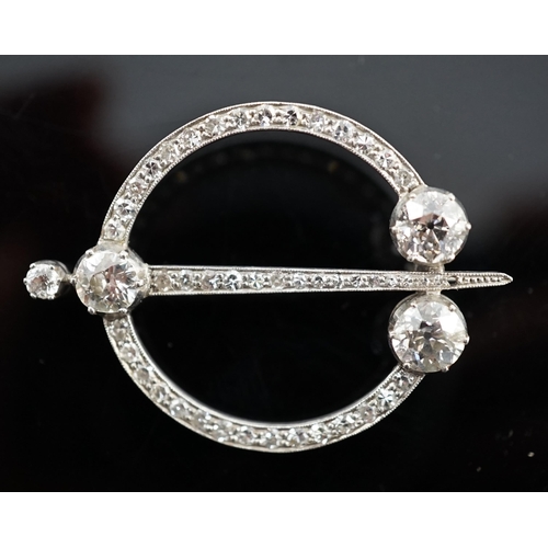 648 - A 1920's platinum or white gold, diamond cluster set openwork 'dagger and circle' brooch, set with c... 