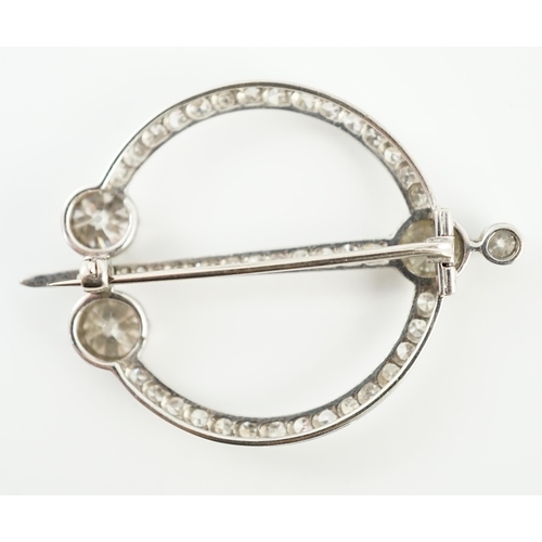 648 - A 1920's platinum or white gold, diamond cluster set openwork 'dagger and circle' brooch, set with c... 