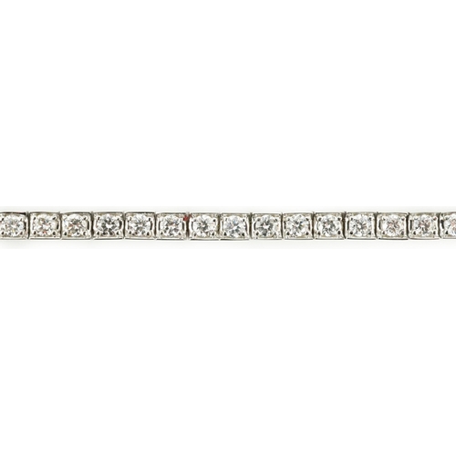 650 - A late 20th century Cartier 18ct white gold and diamond set line bracelet, set with sixty one round ... 