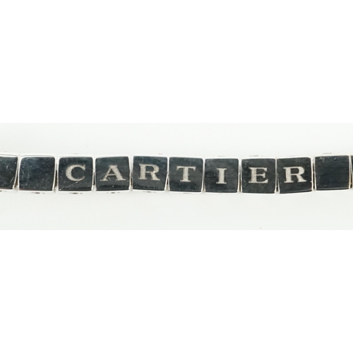 650 - A late 20th century Cartier 18ct white gold and diamond set line bracelet, set with sixty one round ... 