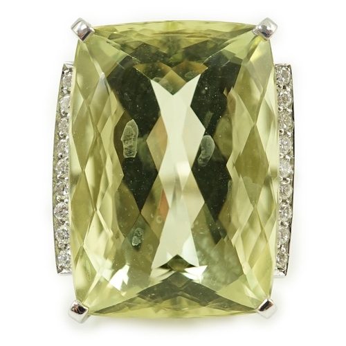 652 - A modern white gold and shaped rectangular fancy cut pale green beryl set dress ring, with diamond c... 