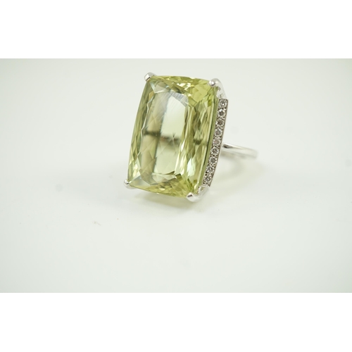 652 - A modern white gold and shaped rectangular fancy cut pale green beryl set dress ring, with diamond c... 