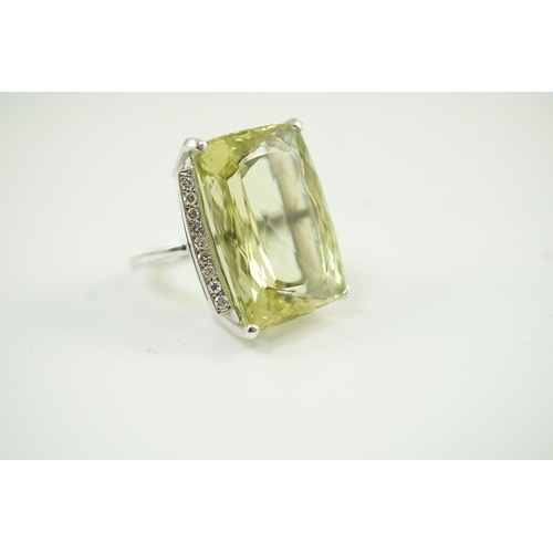 652 - A modern white gold and shaped rectangular fancy cut pale green beryl set dress ring, with diamond c... 