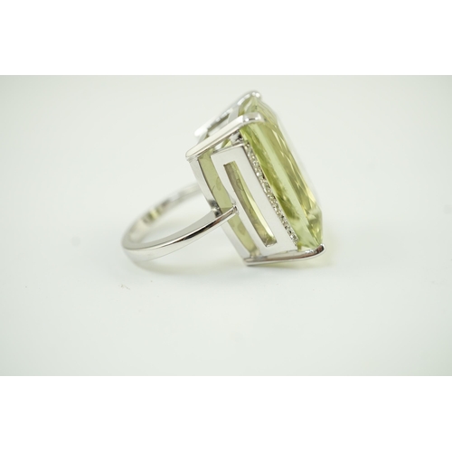 652 - A modern white gold and shaped rectangular fancy cut pale green beryl set dress ring, with diamond c... 