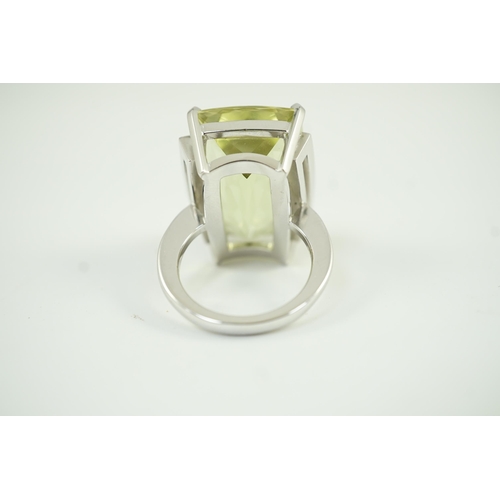 652 - A modern white gold and shaped rectangular fancy cut pale green beryl set dress ring, with diamond c... 