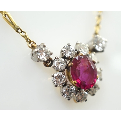 657 - A modern 9ct gold, single stone oval cut ruby and eleven stone round cut diamond cluster set pendant... 