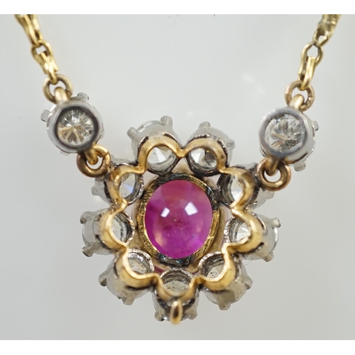 657 - A modern 9ct gold, single stone oval cut ruby and eleven stone round cut diamond cluster set pendant... 