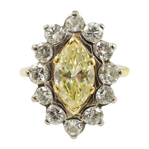 658 - An 18ct gold and single stone fancy yellow diamond set marquise shaped cluster ring with round brill... 