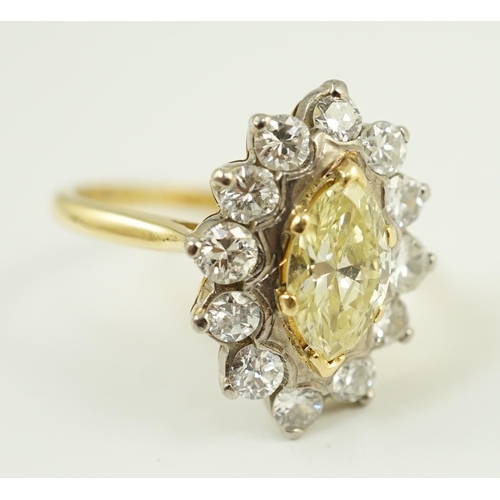 658 - An 18ct gold and single stone fancy yellow diamond set marquise shaped cluster ring with round brill... 