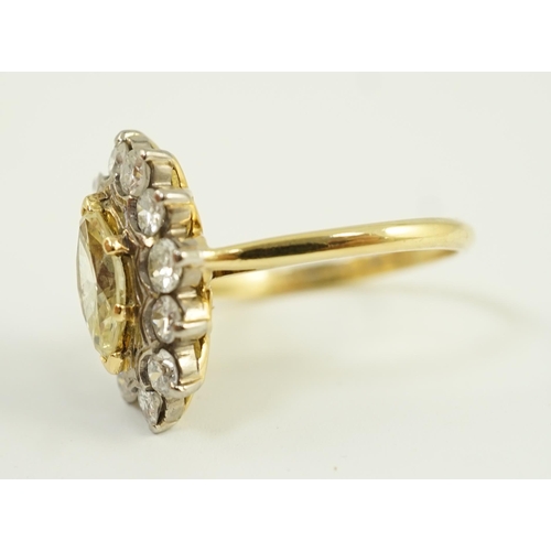 658 - An 18ct gold and single stone fancy yellow diamond set marquise shaped cluster ring with round brill... 