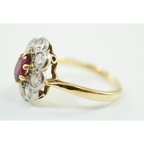 659 - An 18ct gold, claw set single stone ruby and eight stone collet set diamond oval cluster ring, size ... 