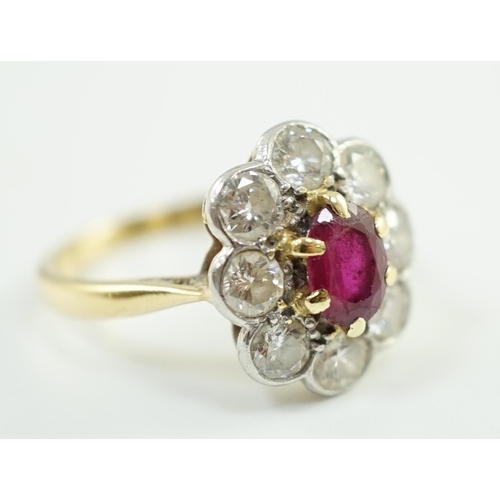 659 - An 18ct gold, claw set single stone ruby and eight stone collet set diamond oval cluster ring, size ... 