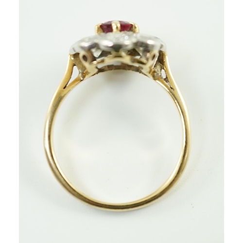 659 - An 18ct gold, claw set single stone ruby and eight stone collet set diamond oval cluster ring, size ... 