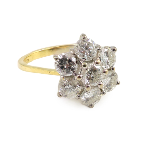 661 - A modern 18ct gold and seven stone diamond set flower head cluster ring, size M/N, gross weight 3.8 ... 