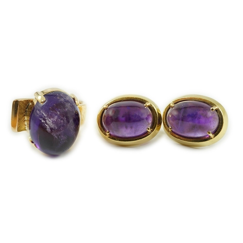 663 - A modern gold and cabochon oval amethyst set dress ring and a pair of similar earrings, ring size I,... 