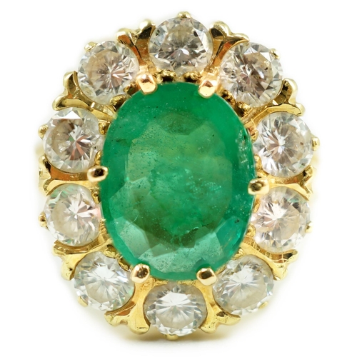 665 - A modern 18ct gold, emerald and diamond set oval cluster ring, size N, gross weight 7.5 grams.... 