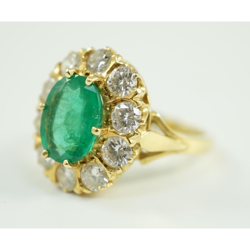 665 - A modern 18ct gold, emerald and diamond set oval cluster ring, size N, gross weight 7.5 grams.... 