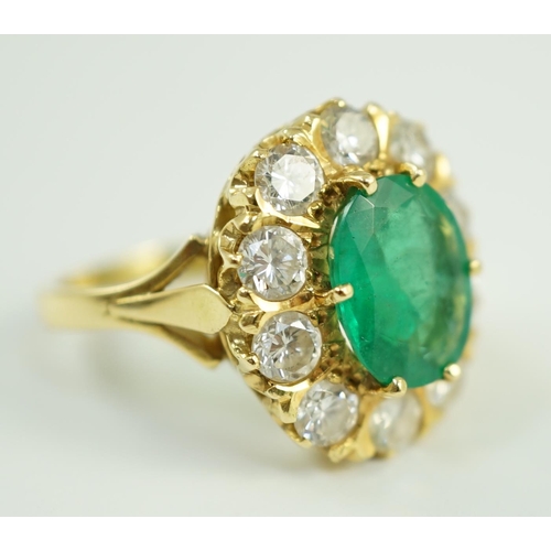 665 - A modern 18ct gold, emerald and diamond set oval cluster ring, size N, gross weight 7.5 grams.... 