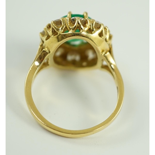 665 - A modern 18ct gold, emerald and diamond set oval cluster ring, size N, gross weight 7.5 grams.... 