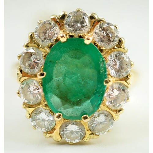 665 - A modern 18ct gold, emerald and diamond set oval cluster ring, size N, gross weight 7.5 grams.... 