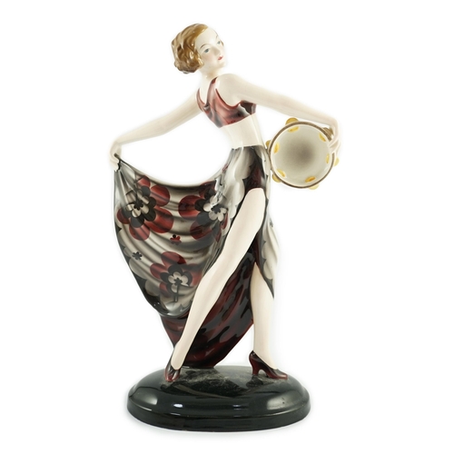 73 - Stefan Dakon for Goldscheider, an Art Deco pottery figure 'Tambourine Dancer', c.1935, with maroon, ... 