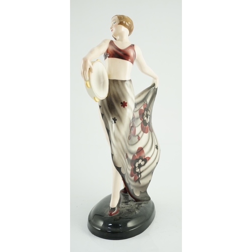 73 - Stefan Dakon for Goldscheider, an Art Deco pottery figure 'Tambourine Dancer', c.1935, with maroon, ... 