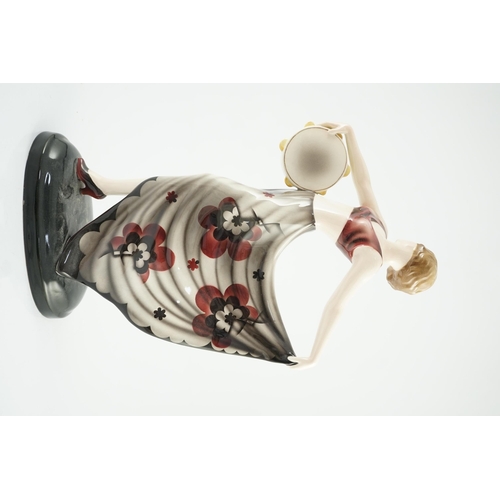 73 - Stefan Dakon for Goldscheider, an Art Deco pottery figure 'Tambourine Dancer', c.1935, with maroon, ... 