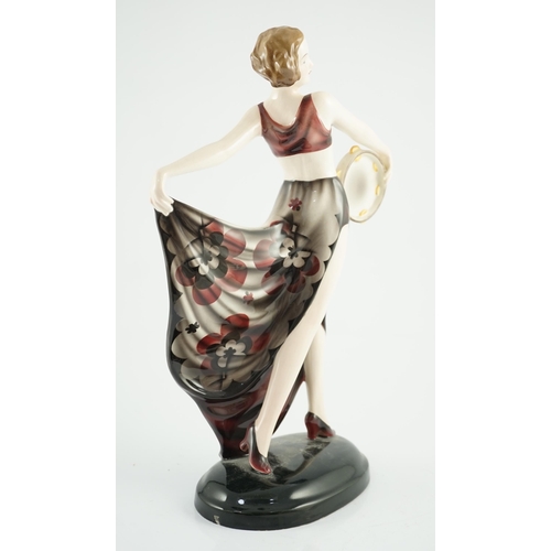 73 - Stefan Dakon for Goldscheider, an Art Deco pottery figure 'Tambourine Dancer', c.1935, with maroon, ... 