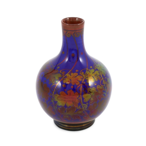 76 - A Pilkingtons Royal Lancastrian copper lustre bottle vase, by Gordon M. Forsyth, decorated with copp... 