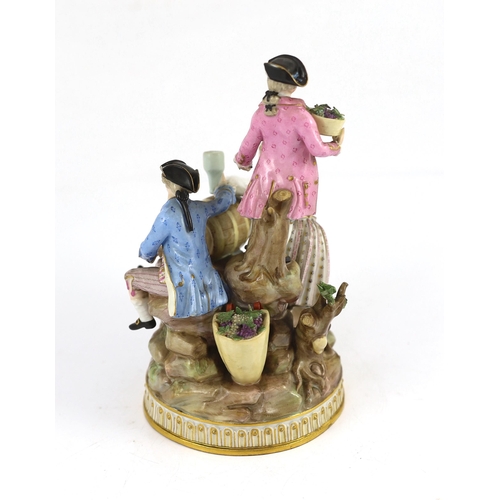 78 - A Meissen group of grape pickers with barrels of wine, 19th century, modelled on a rockwork and tree... 