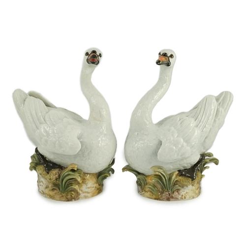 82 - A pair of large Meissen models of swans, 19th century, each outside decorated, the swans seated on a... 