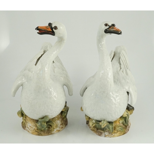 82 - A pair of large Meissen models of swans, 19th century, each outside decorated, the swans seated on a... 