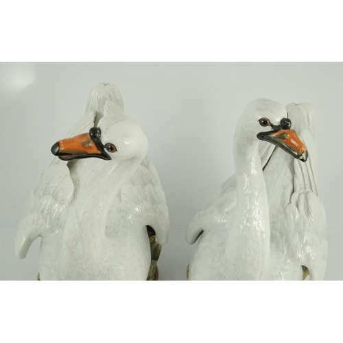 82 - A pair of large Meissen models of swans, 19th century, each outside decorated, the swans seated on a... 