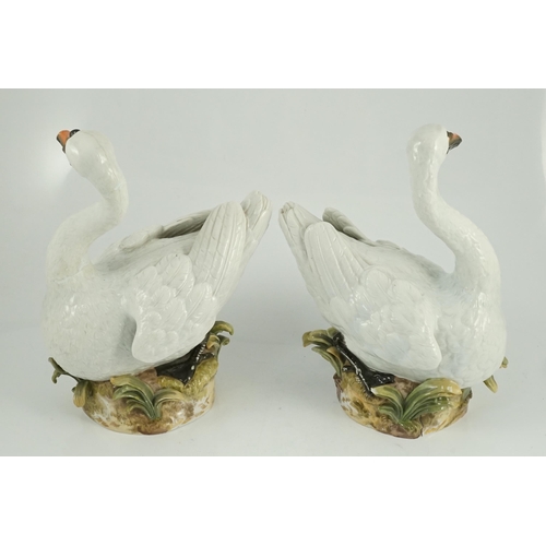 82 - A pair of large Meissen models of swans, 19th century, each outside decorated, the swans seated on a... 