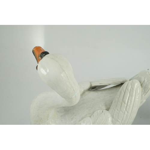 82 - A pair of large Meissen models of swans, 19th century, each outside decorated, the swans seated on a... 