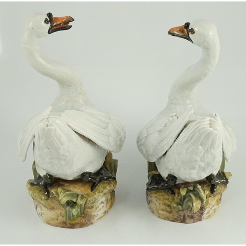 82 - A pair of large Meissen models of swans, 19th century, each outside decorated, the swans seated on a... 