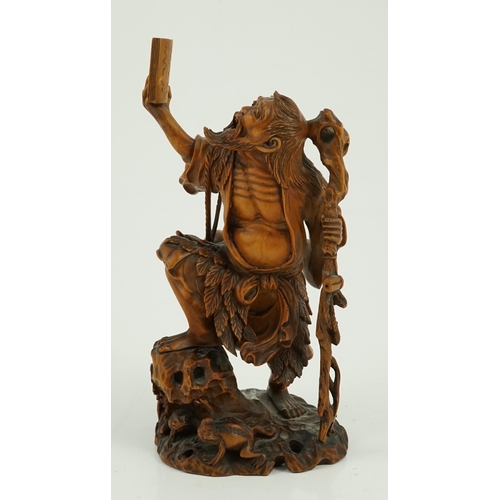 98 - A Japanese boxwood okimono of Gama Sennin and two toads, 19th century, the crisply carved figure hol... 