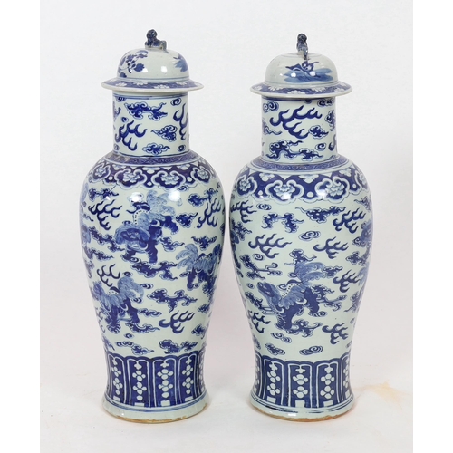 121 - A pair of large Chinese blue and white Buddhist lion vases and covers, 19th century, each painted ... 