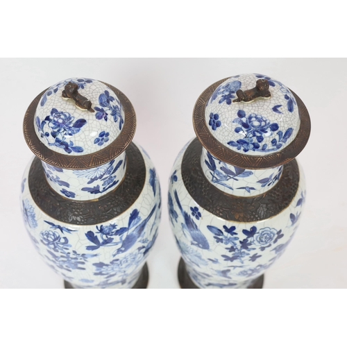 128 - A pair of large Chinese blue and white crackle glaze vases and covers, late 19th century, each paint... 