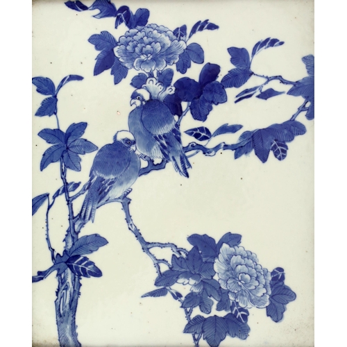 129 - A Chinese blue and white wall plaque, late 19th century, painted with two birds perched in a peony t... 